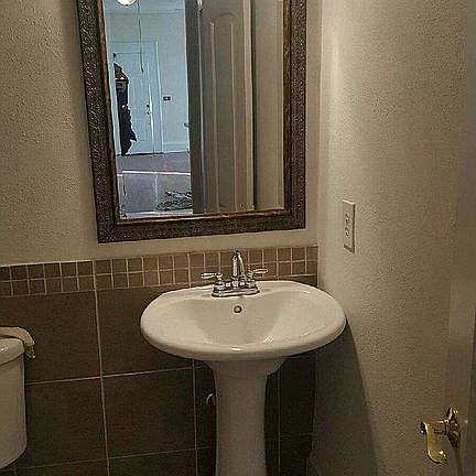 Pedestal sinks and tile wainscoting