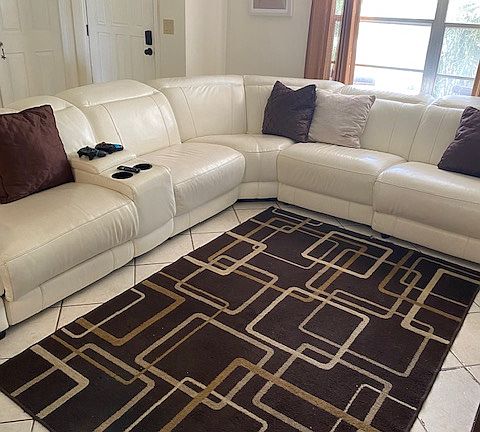 Leather Sofa with built in remote/Cell Phone holders and room for your favorite beverage. Some of the Couch has pullout Feet Rest too.