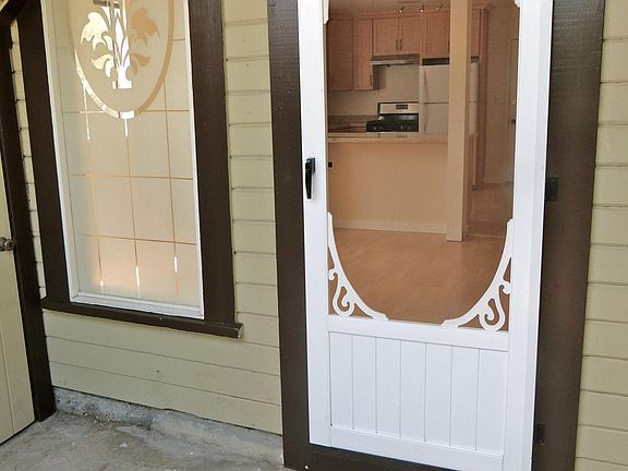 Screen door at entrance looking into living room.