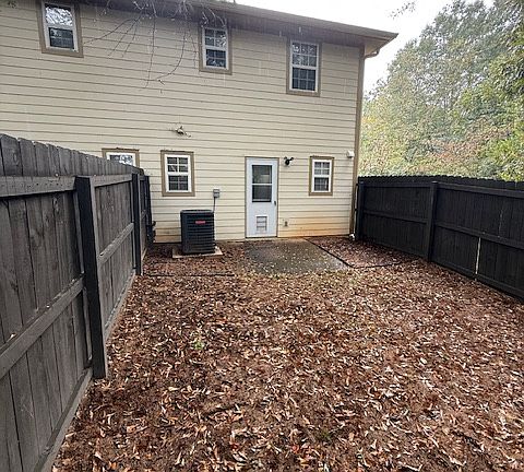 Back of unit 308, fenced in with pet door.