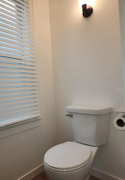 New downstairs half-bath, pocket door, two lights, one window, new luxury vinyl floor