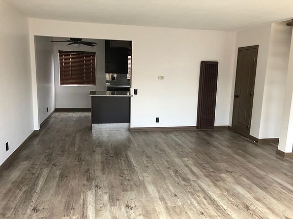 From front door into living room looking into dining area on left and kitchen