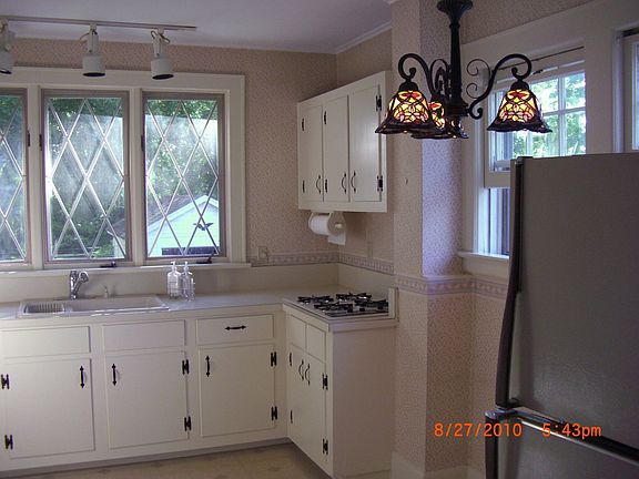 View of kitchen cabinets and windows