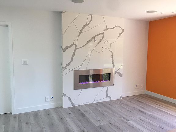 fireplace with wall to ceiling extra jumbo quartz slab. TV hanger ready!