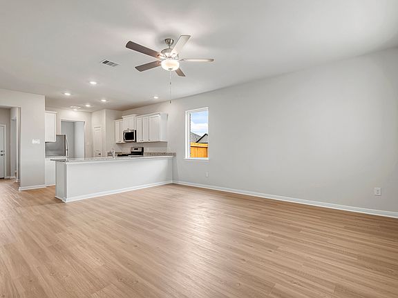 A spacious family room and adjoining kitchen
