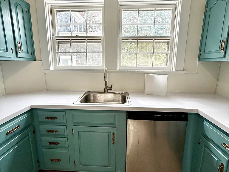 Bright kitchen with ample cabinets, dishwasher, side by side stainless refrigerator with in-door ice maker & water, gas stove