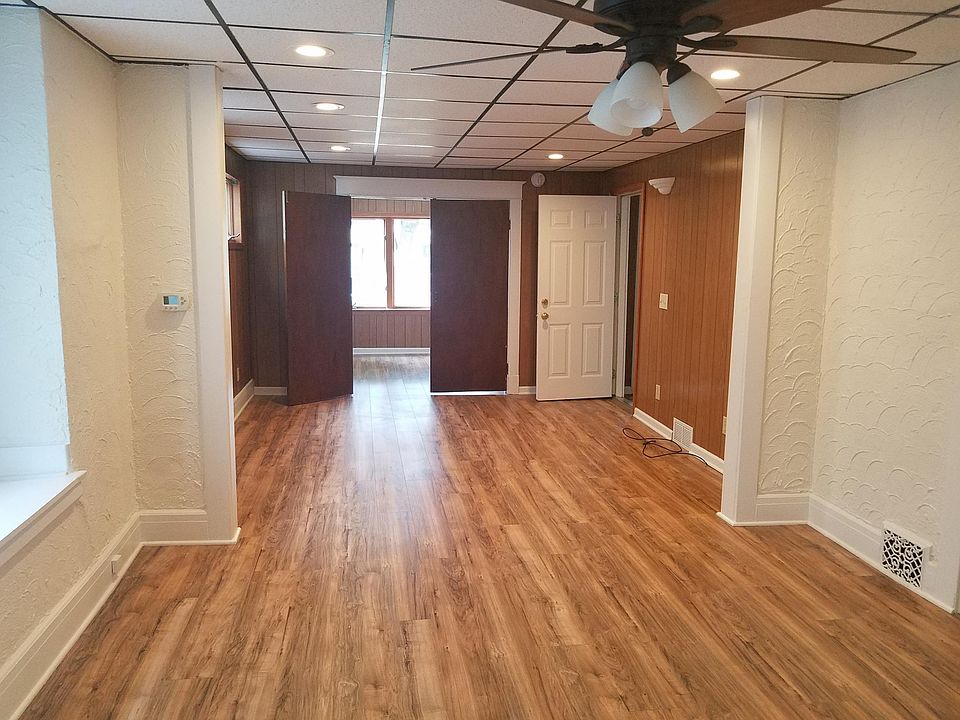 Dining room, living room, and front of house den/sunroom with doors