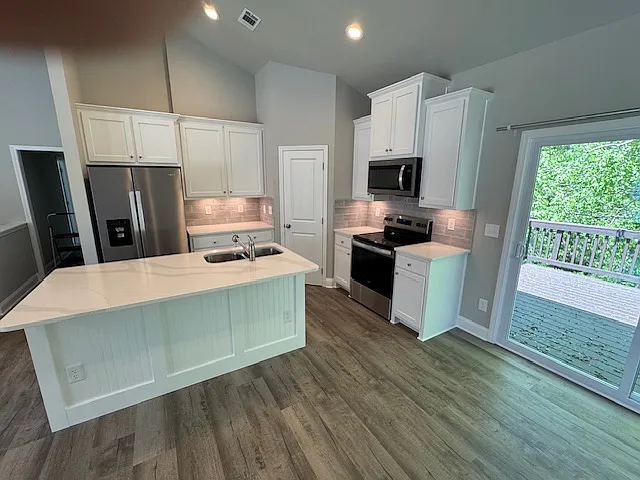 Kitchen with Stainless Appliances, Undercounter lighting, quartz countertops and 3 person bar seating