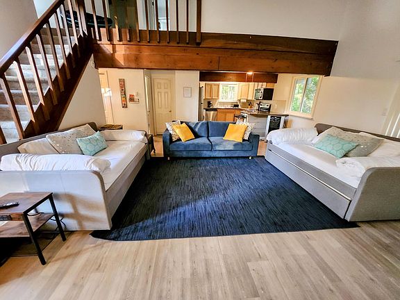 Living room with a sofa and 4 twin beds