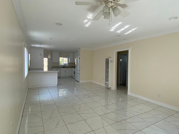 Another view of the living room, kitchen and door on the right to the bedrooms and bathroom.