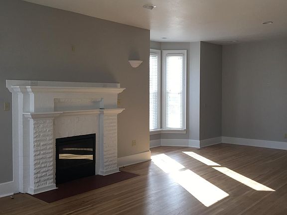 Living room features an electric fireplace