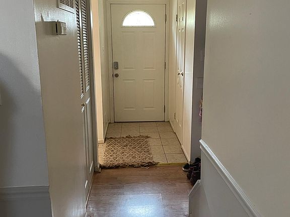 Hall way facing the back of the front door (Left to the kitchen area, right to the powder room.