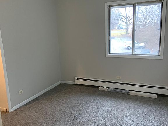 Bedroom 1 overlooking the back parking lot.