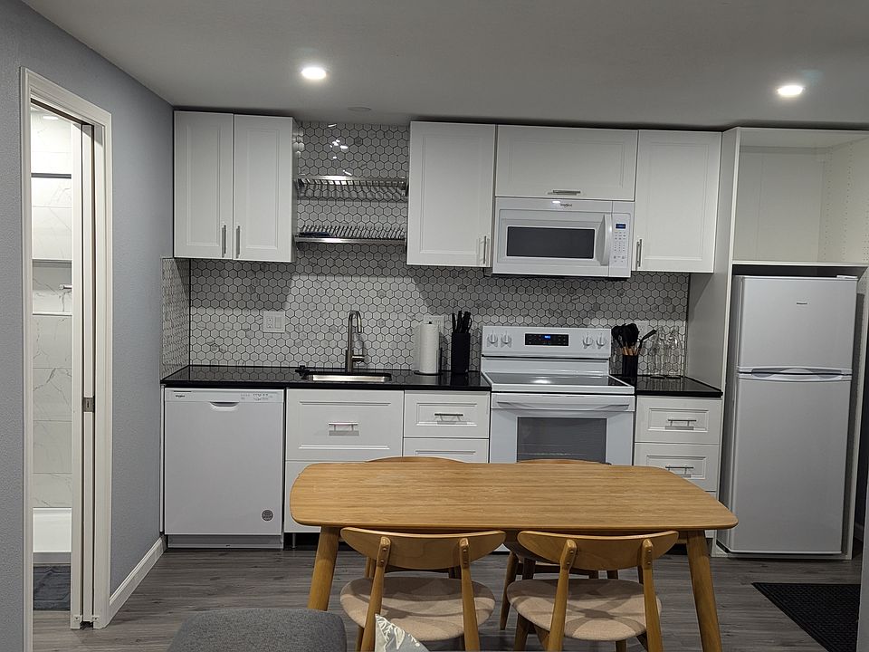 Fully stocked kitchen with dishwasher and trash compactor