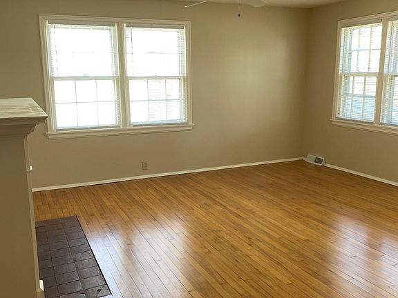 Living room with fireplace. Fresh refinished hardwood floors and all new paint.