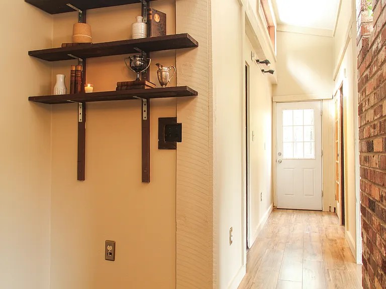 Bookshelves/library nook. Natural light flooding the cabin from the row of skylights above.