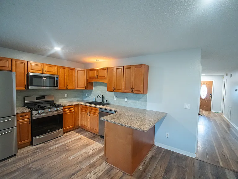 Dishwasher, fridge, gas range, and microwave.