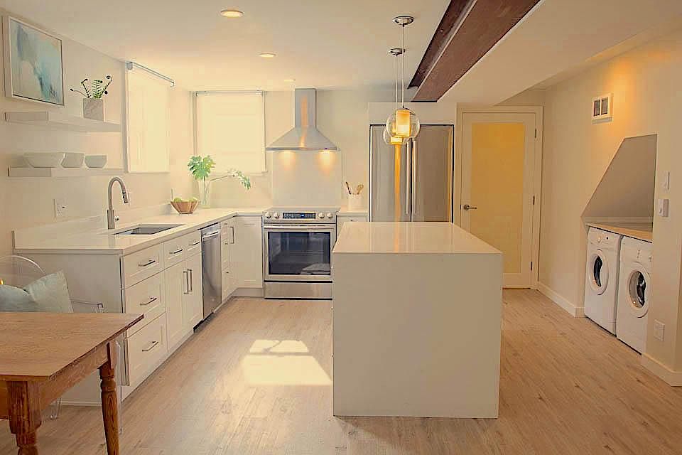 Huge waterfall Island. Left side of Island has extensive drawers. Frosted glass door is entry to large pantry. Convenient in unit washer and dryer.
