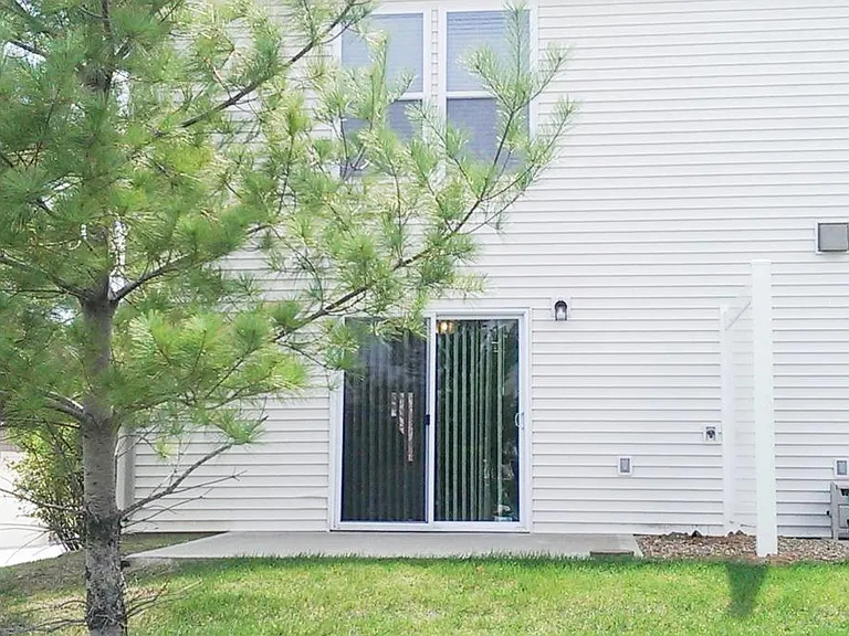back patio with privacy fence and trees