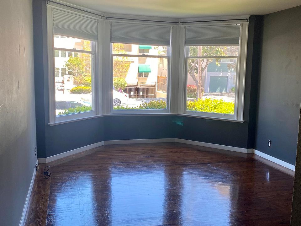 Large bay windows in the living room. Hardwood floors.