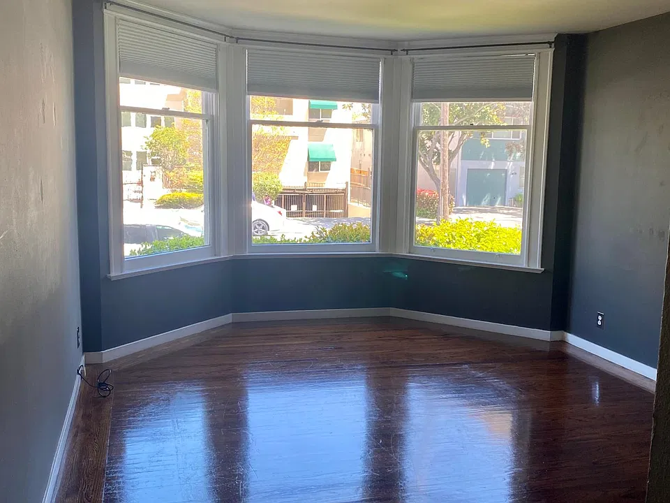 Large bay windows in the living room. Hardwood floors.