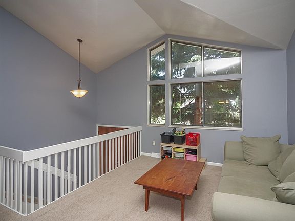 Large living room with a wall of bright windows.