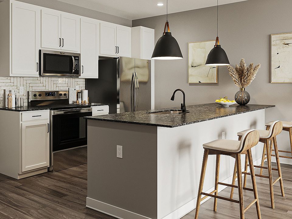Step into a beautifully designed kitchen featuring stylish decor and ample space for dining and entertaining.