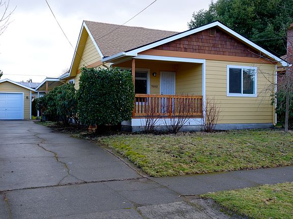 Front view with driveway and garage
