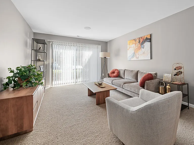 Spacious Living Room with Sliding Glass Door at Lakeside Village Apartments Clinton Township MI