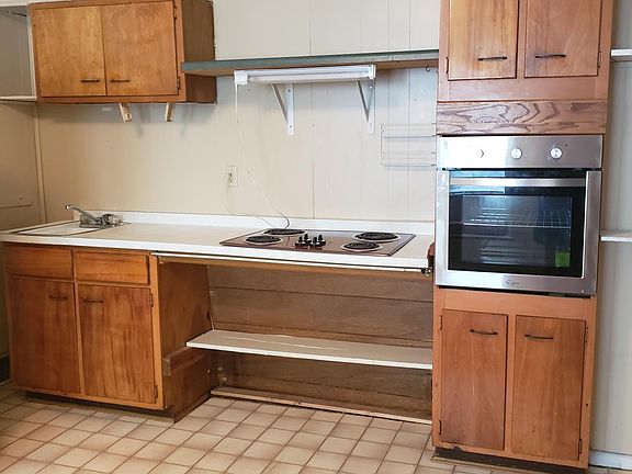 kitchen showing stove top, oven and cabinets.
