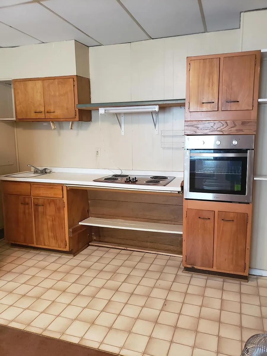 kitchen showing stove top, oven and cabinets. - 208 W Oak St #D