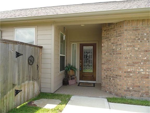  The front is enhanced by a leaded glass door and paver entry.