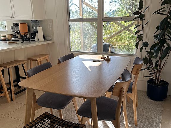 And an example of what the kitchen looks like with a dining table. Lots of room for plants and furniture.
