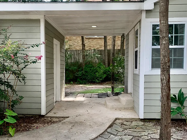 Walkway between garage (left) and house