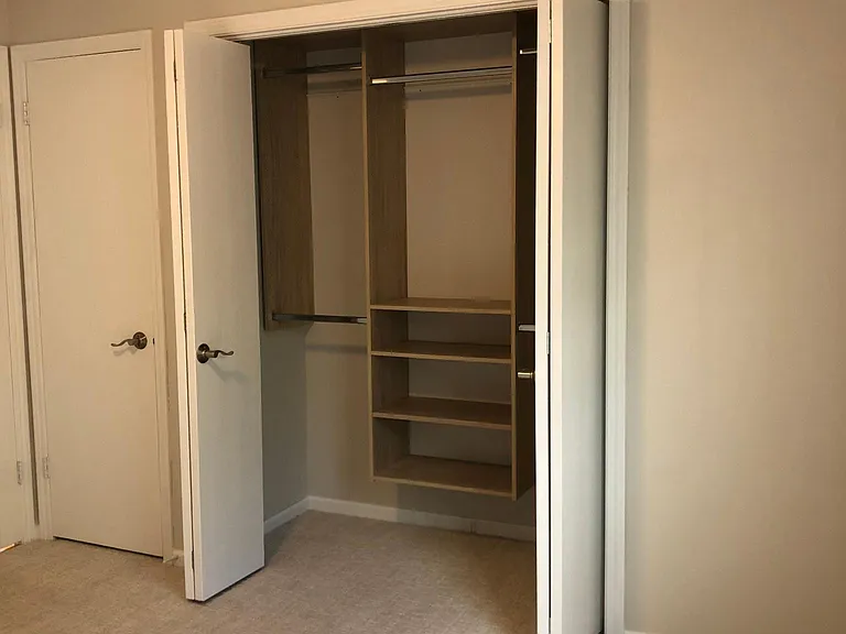 1st Bedroom showing closet system ( other door is furnace closet )