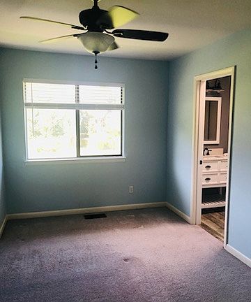 Master bedroom has a walk in closet, and a view of the water and grassy area behind the unit. Huge tub and shower with a skylight