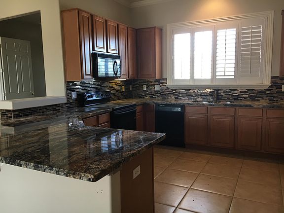 Kitchen with new granite counter top, sink, faucet, and refrigerator