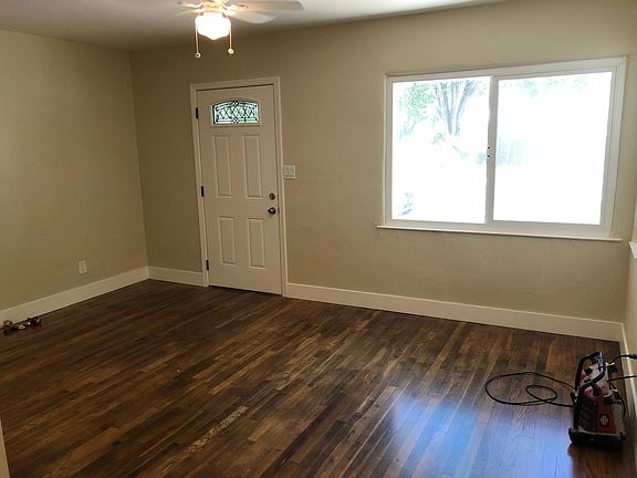 Living Room with new flooring, paint, baseboard, ceiling fan