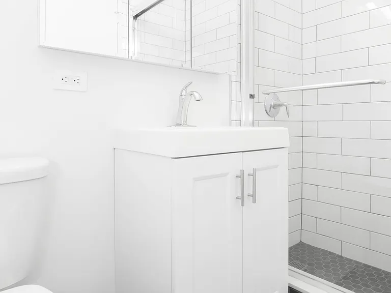 Step into modern living at The Century with this sleek bathroom featuring pristine white tiles and contemporary fixtures. Elevate your daily routine in a space designed for comfort and style. Schedule a tour today to see it in person!