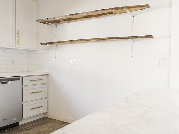 Kitchen wall with open exposed wood shelfs