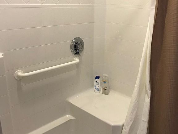 Full walk in tub- built in shower chair and grab bars attach