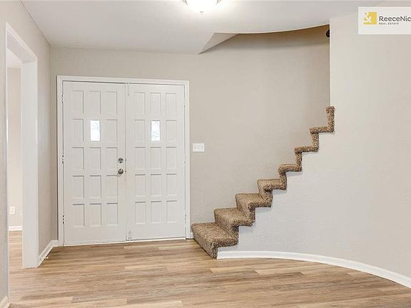 Entry with Curved Staircase to Upper Level