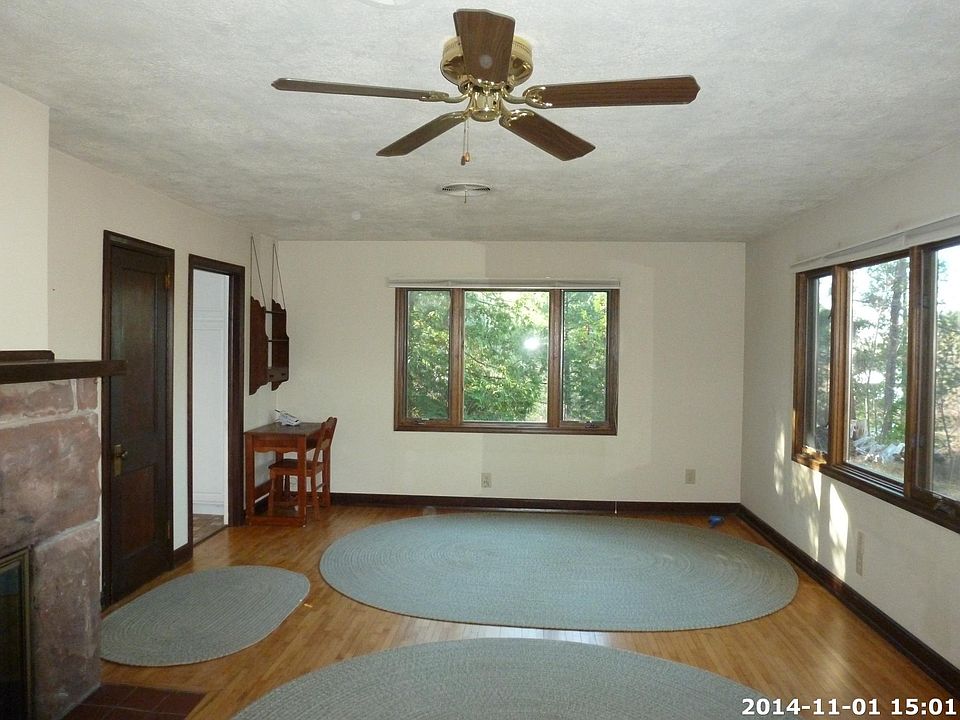 Living room with sandstone hearth, birdseye maple flooring,