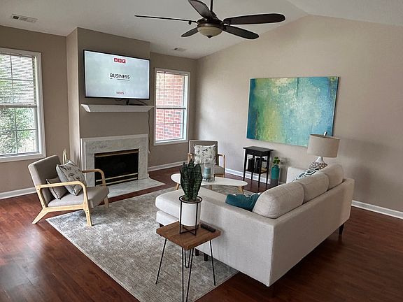 Living room with cathedral ceiling and ceiling fan