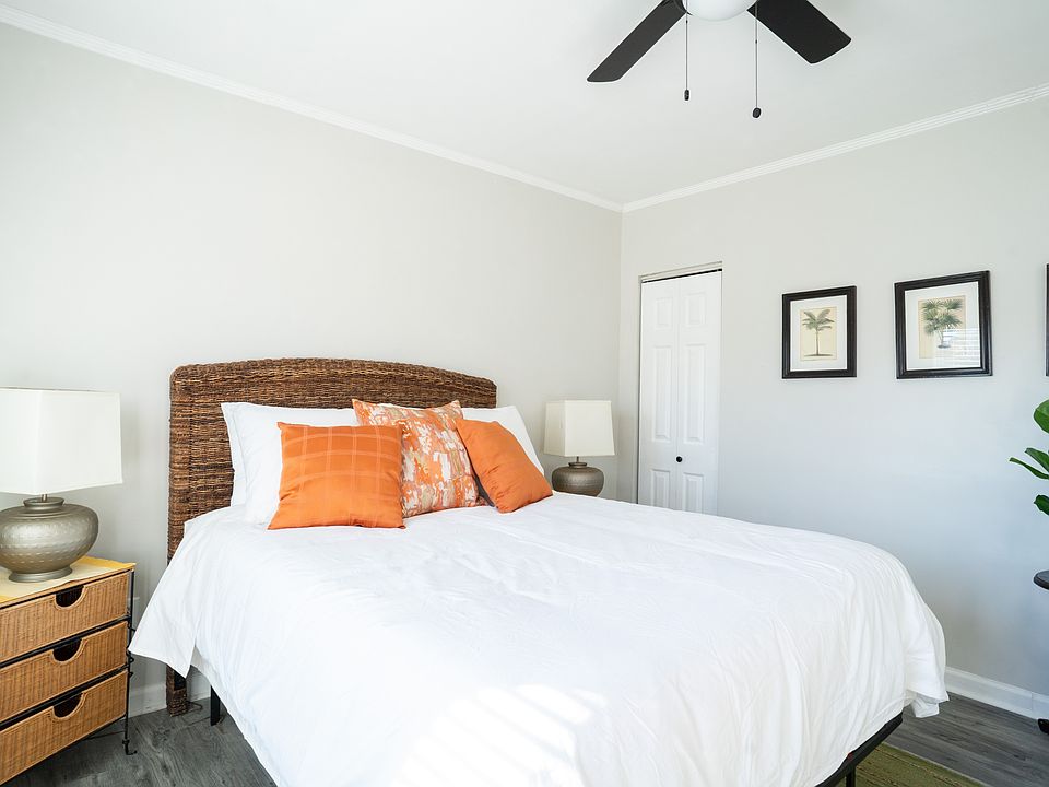Bedroom with seating area mountedTV and desk