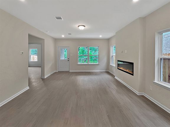 The Sparrow II- Family Room with Linear Electric Fireplace. Home under construction. Sample floor p