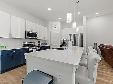 Eight foot long kitchen Island, with four bar stools is great for food prep and entertaining.