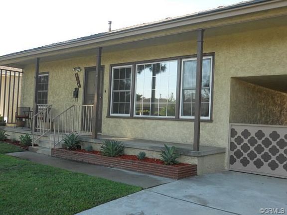 drive thru carport on right side leads to backyard & 2 car detac