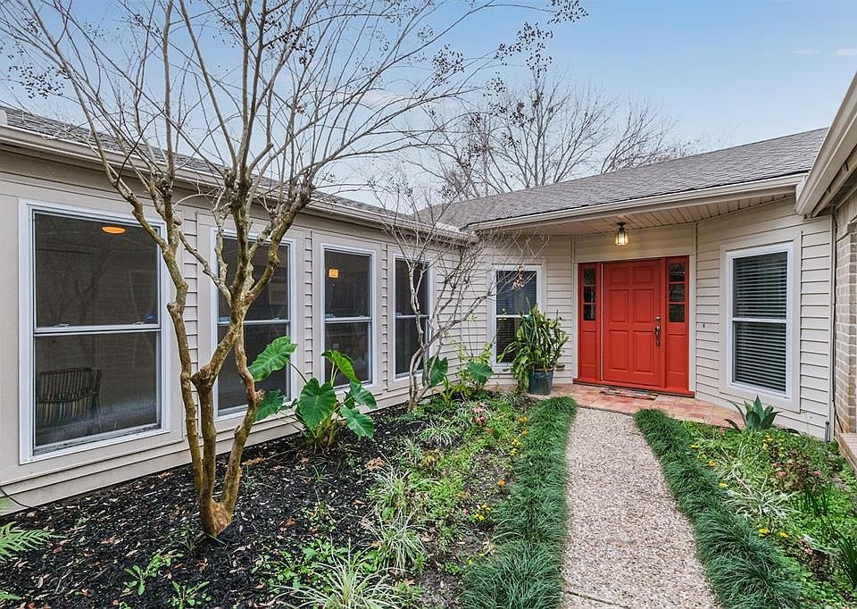 Gated courtyard entry to the front door of this wonderful one story home. Kitchen on the left and master bedroom on the right.