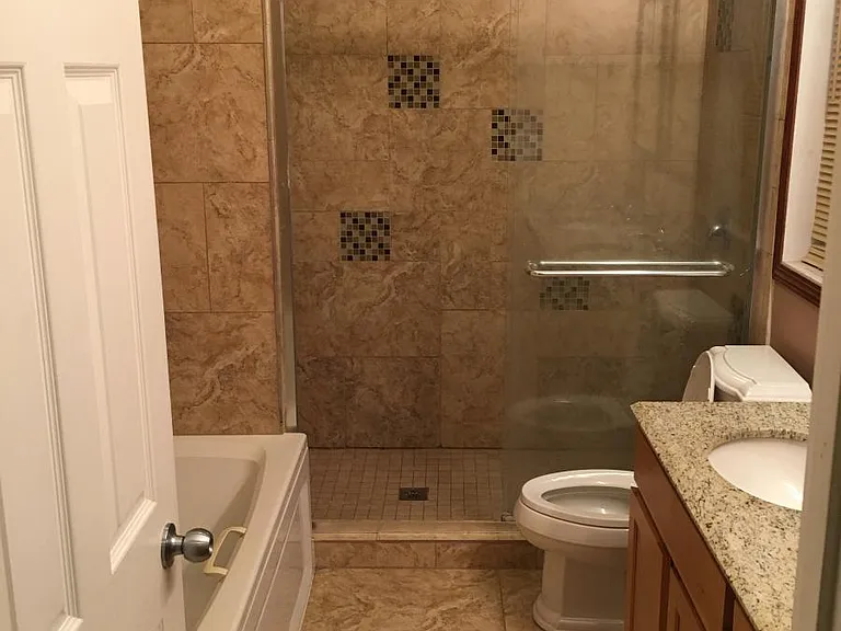 Upstairs 2nd bathroom shared by guests in 3 bedrooms. Separate shower and bathtub with dual vanity sinks.